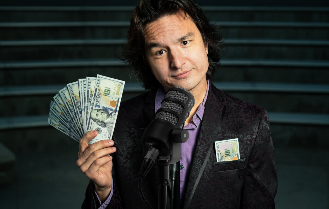 Podcaster holding money.
